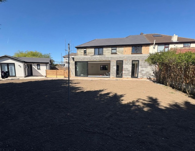 Blockwork extension with sliding doors under a blue sky