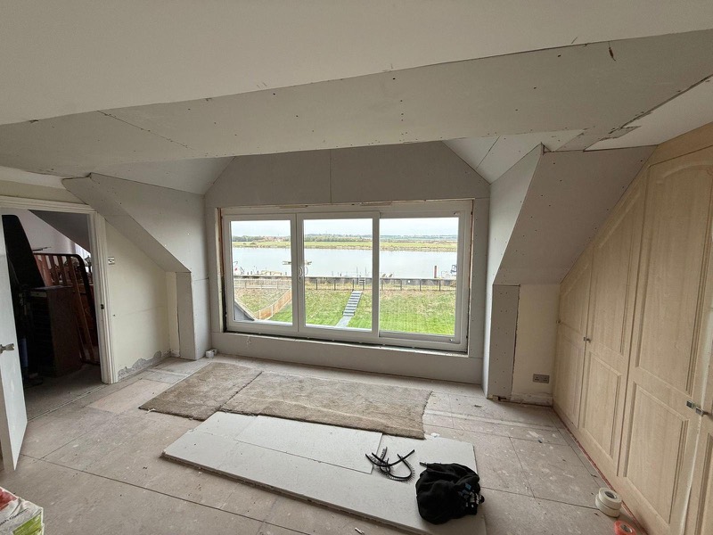 Boarded out room in the roof with a view over the water