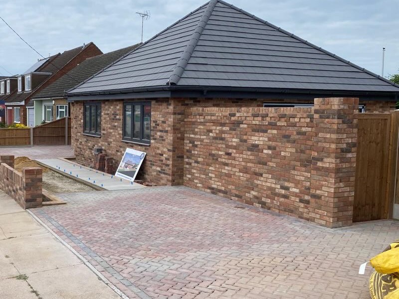 Brick bungalow with a hipped tiled roof