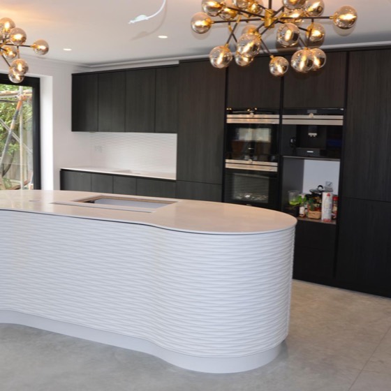 Dark oak kitchen with a curved ripple island
