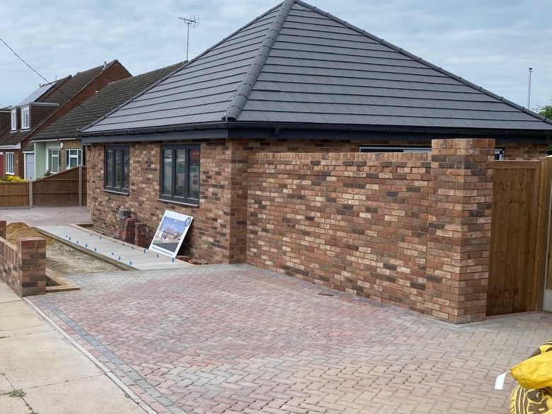 Brick bungalow in Benfleet with a hipped tiled roof and block paved drive