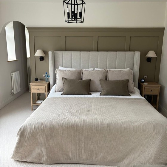 Olive panelled wall and lantern pendant in a main bedroom