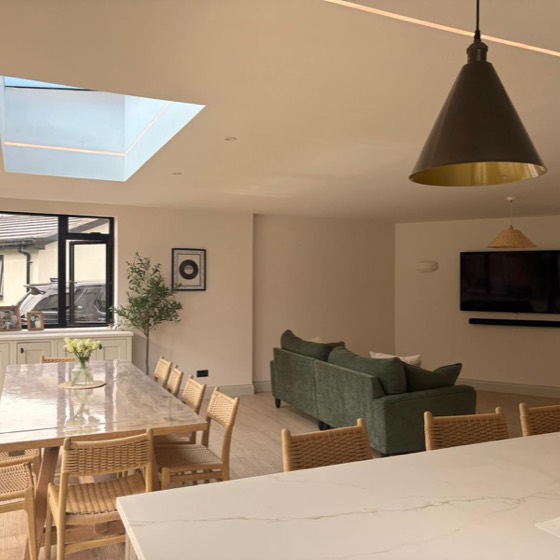 Open plan kitchen and lounge under a skylight