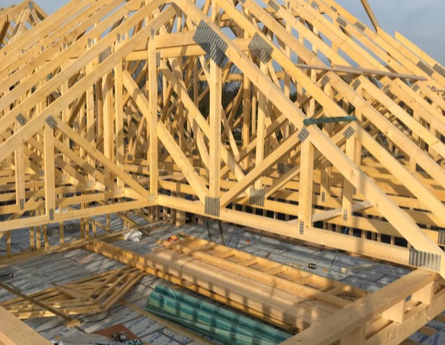 Timber roof trusses going up